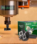 Pro Grade CNC Spoilboard Surfacing Router Bit With Four Wings Half Inch Shank One And A Half Inch Cutting Diameter Slab Flattening Bit for CNC Routers, shown installed in a machine with packaging in the background.