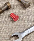 Red stop from Six Piece Aluminum Alloy Woodworking Bench Dog Clamps, Low Profile Desktop Tenon Design on woven surface