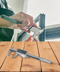 Jewelry Measurement Tool 150mm Digital Caliper(150MM) used in hands, measuring a ring's size with precision on a wooden surface.