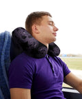 Man using Purple Black Goth Spooky U Shaped Travel Pillow For Neck Support on a bus, showing memory foam comfort and portability