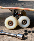 Heavy Duty M8 Locking Nuts For Skateboard Trucks 50 Piece Bombproof Iron Hardware Kit alongside skateboard wheels and tools.