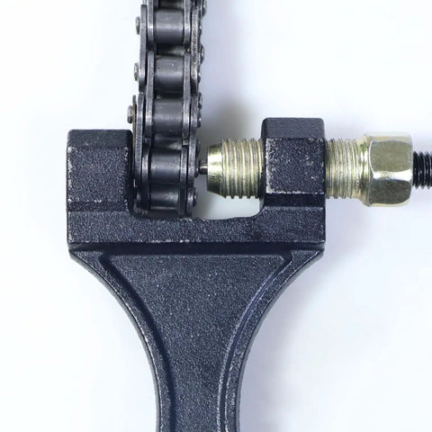 Heavy Duty Chain Breaker Tool For Motorcycle ATV Dirt Pit Bike Go Kart Scooter And Bicycle Chains 420 428 520 525 528 530 Ideal For DIYers And Quick On The Fly Chain Breaks in action, showing close-up of tool breaking a chain.