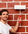 Man using 8 Inch Brick Pattern Embossing Paint Roller For Wall Decor DIY Easy Home Art Rubber Handle Embossing Cylinder
