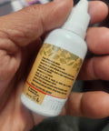 Cuticle Remover Liquid 32ml For Manicure And Pedicure At Home Nail Care Soften Cuticles Quickly With A Gentle Fast Acting Formula For Pro Quality Nails You Can Push Back Easily And Keep Your Hands Looking Fresh. white dropper bottle in hand
