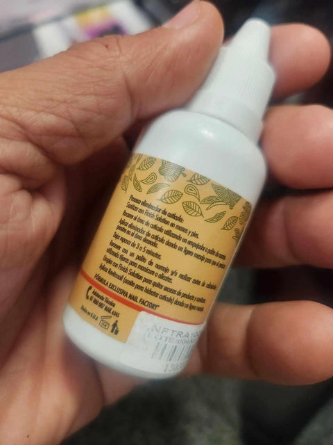 Cuticle Remover Liquid 32ml For Manicure And Pedicure At Home Nail Care Soften Cuticles Quickly With A Gentle Fast Acting Formula For Pro Quality Nails You Can Push Back Easily And Keep Your Hands Looking Fresh. white dropper bottle in hand