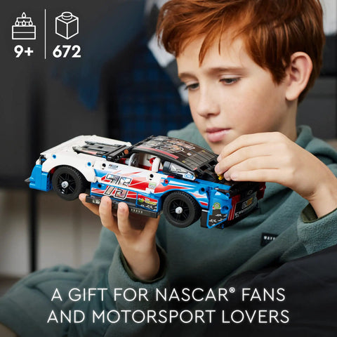 Child holding Next Gen NASCAR Chevrolet Camaro ZL1 Race Car Build Kit For Kids 9 And Up Collectible Model Toy with realistic details