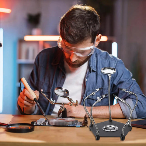 Man using Soldering Helping Hands With 3X Magnifying Glass 4 Rotatable Alligator Clips Magnetic Base Stand Gooseneck Arms for PCB repair