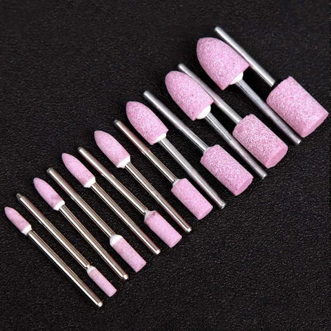 Pro Grade 100 Pcs Abrasive Stone Points Kit for Dremel Rotary Tool Polishing Grinding Heads with pink abrasive points on black background