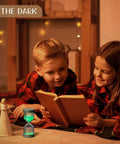 Children reading with Nine Colorful Luminous Sand Timers Set in background, glow-in-the-dark hourglasses for cozy home vibe.
