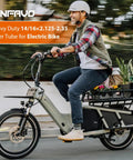 Man riding electric bike with rugged heavy duty 16x2.125 inch e bike inner tube with bent valve stem, product by Winfavo.