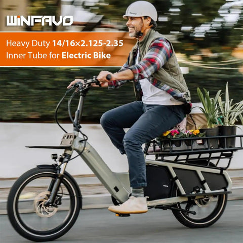 Man riding electric bike with rugged heavy duty 16x2.125 inch e bike inner tube with bent valve stem, product by Winfavo.
