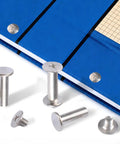 Kickass Chicago Binding Screws With Phillips Cross Head Design Heavy Duty Carbon Steel Stud Posts And Nickel Plated Rivet Kit on blue notebook.