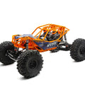 RBX10 Ryft 4WD Brushless RC Rock Bouncer, orange rugged tube chassis, solid front and rear axles, side view, no battery or charger