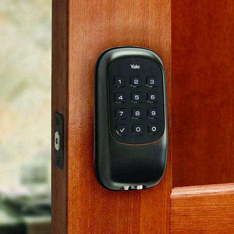 Black keypad deadbolt lock on wooden door, backlit keypad visible for Keypad Deadbolt Lock With Backlit Keypad, Auto Relock, And Custom Access Codes For Keyless Entry, Delete Codes Anytime, Keepin Your Home Safe In Satin Nickel Finish.