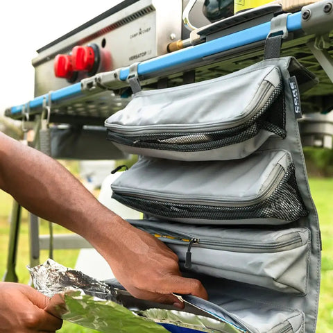 Hanging Organizer For Outdoor FlexRail Camp And Cook Table, Durable Weather Resistant Pocketed Storage, shown attached to a table.