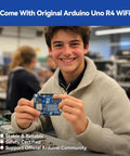 Smiling student holding Arduino Uno R4 WiFi from All In One Arduino Starter Kit With Uno R4 WiFi Bluetooth IoT ESP32 LCD1602 OLED 300 Plus Components 60 Plus Free Video Lessons 50 Projects RoHS Compliant Online Tutorials And Video Courses For Beginners And Engineers in a classroom.