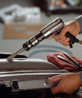 Quick Change Air Hammer Kit With 3 Piece Chisel Set 3500 BPM Two And Five Eighths Inch Stroke Point Four Zero One Shank in use on metal