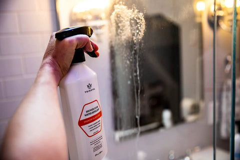 Person applying Shower Door Glass Protectant That Makes Water Bead Off, A Water Repellent Sealant For Glass Doors on shower door.