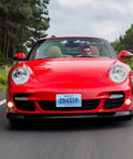 Red sports car with Slick Stainless Steel License Plate Frame Slim Style Two Hole Mount Polished Finish Flat Plate Holder on highway.