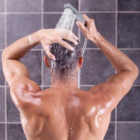 Man using Dual Shower Head System With Rainfall Top Spray And Handheld 70 Inch Flexible Hose Smooth 3 Way Diverter Easy Install Chrome Finish 2 In 1 Shower Head Combo in bathroom.