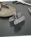 Concealed stainless steel door hinge with dual mounting plates, front view