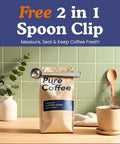 Coffee bag with Free 2 in 1 Spoon Clip against green tile wall, wooden spoon and cup, greenery in vase