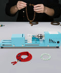 Compact Mini Wood Lathe And Milling Machine For Engraving Sanding Cutting Multi Purpose Tabletop Tool in use with bead crafting.