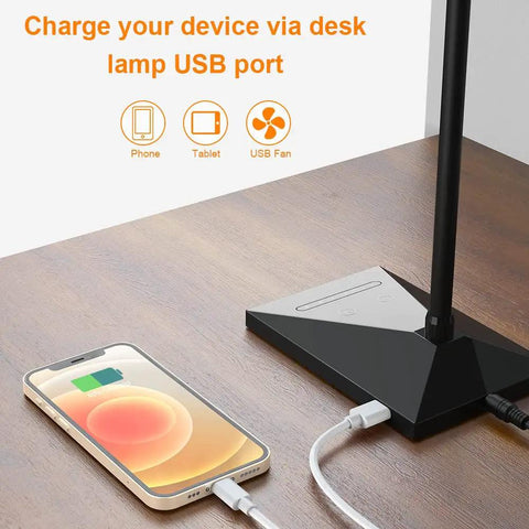 Dope LED Desk Lamp With USB Charging Port on wooden desk charging a smartphone, black base visible, modern design.