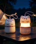 Two Pack Unicorn Themed Kids Camping Lanterns With RGB Multicolor Lights on picnic table at night, outdoor background