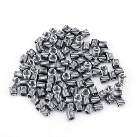 Top Notch 100 Pcs M4 Helical Wire Thread Inserts For Replying Stripped Threads in Aluminum and Soft Metals With Durable Stainless Steel Construction That Lasts A Lifetime - pile of stainless steel M4 inserts.