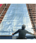 Person applying Heavy Duty Aluminum Roof Tape Tough As Nails Butyl Asphalt Sealant on a roof for leak protection.