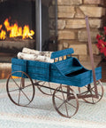 Amish Wagon Garden Planter On Wheels for Indoor Outdoor Decor Blue, Farmhouse Chic Style Wood Wagon by a fireplace with logs.