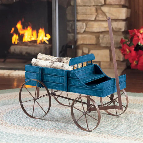 Amish Wagon Garden Planter On Wheels for Indoor Outdoor Decor Blue, Farmhouse Chic Style Wood Wagon by a fireplace with logs.