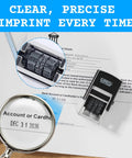 Pro Level Self Inking Date Stamp With Built In Black Ink Reservoir And Quick Twirl 12 Year Calendar Knob on paperwork.