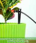 100 Pack Drip Irrigation Stakes For One Quarter Inch Tubing in use with green pot, securing tubing for plant watering