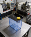 Tough As Nails Three Liter Coolant Reservoir With Integrated Filter For Cnc Mill Lathe And Drill on a workbench in a machine shop.