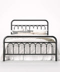 Rock Solid Queen Size Metal Platform Bed Frame With Victorian Scrollwork Headboard in black, showcasing a cozy bedding arrangement.