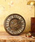 18 Inch Moving Gears Wall Clock Oversized Industrial Steampunk Design With Antique Oil Rubbed Bronze Finish displays gear face on wooden tabletop.