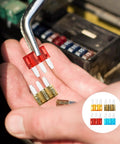 Person holding Micro 3 Blade Automotive Fuse Kit With See Through Windows, 6 Pack Each Of 5A 7.5A 10A And 15A Fuses, 24 Piece Set
