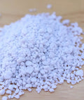 Organic Perlite For Gardening A Lightweight Soil Aerator That Prevents Compaction And Boosts Root Growth In Pots And Garden Beds No Fuss And Easy To Use Natural 100 Percent Perlite With Neutral PH Pack Of 1 showing loose white granules on wood surface
