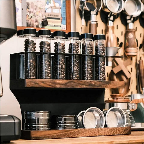 Transform Your Counter Into A Lowkey Essential Coffee Bar With This Badass 2 Tier Organizer Stand Built On Solid Wood And Carbon Steel Frame Holds 12 Airtight Bean Canisters One Way Valves Plus Pour Funnel, showcasing coffee bean canisters and a pour funnel.