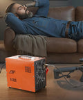Heavy Duty Portable PCP Air Compressor Pump Crushes Four Thousand Five Hundred PSI with dual display near a man relaxing on a couch.