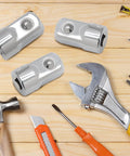 Three chrome-plated 1/4 to 1/2 inch drive socket adapters (Cr-V) on a wooden work surface with tools