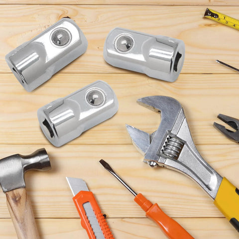 Three chrome-plated 1/4 to 1/2 inch drive socket adapters (Cr-V) on a wooden work surface with tools