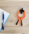 Phone Screen Opening Tool Kit With Suction Cup And Pliers For Quick Repairs on wooden table with notebook and pen
