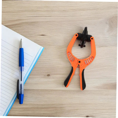 Phone Screen Opening Tool Kit With Suction Cup And Pliers For Quick Repairs on wooden table with notebook and pen
