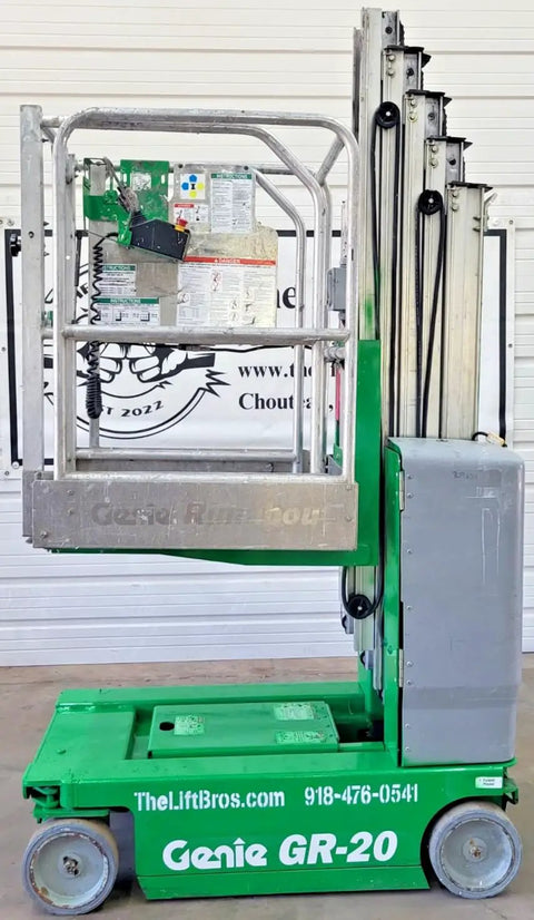 2016 Compact Self Propelled Electric Vertical Mast Lift Featuring Slick Drivability At Full Height, side view with control panel and lift extended.