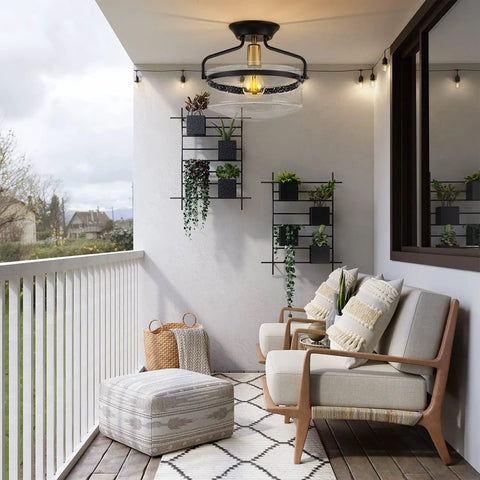 Seeded Glass Semi Flush Mount Ceiling Light In Matte Black, 11.2 Inch Shade illuminating a modern porch with seating and plants