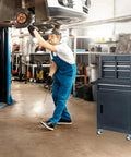 Heavy Duty Metal Rolling Tool Cart With Drawers For Power Tools And Workshop Organization Black On Wheels Large Garage Storage Cabinet With Four Rugged Wheels shown in a garage workshop setting.