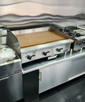 Custom Rollout Food Trailer Kitchen Unit Featuring Heavy Duty Refrigerator Commercial Sink And Stainless Steel Juicer Station Ideal For Coffee Kiosks Ice Cream Booths And Street Snacks Ready To Hustle Urban Pavement Daily - stainless steel grilling area with burners and refrigerator.